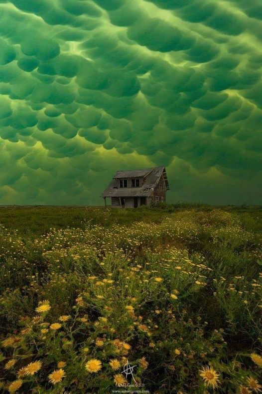 Green mammatus clouds, which usually precede a tornado, over an abandoned house... 1