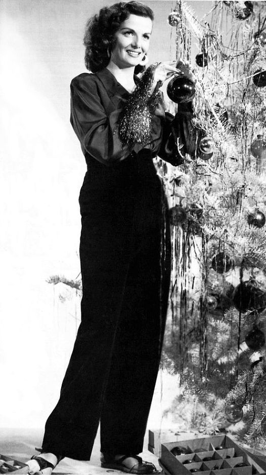 Jane Russell trimming the tree.... 1